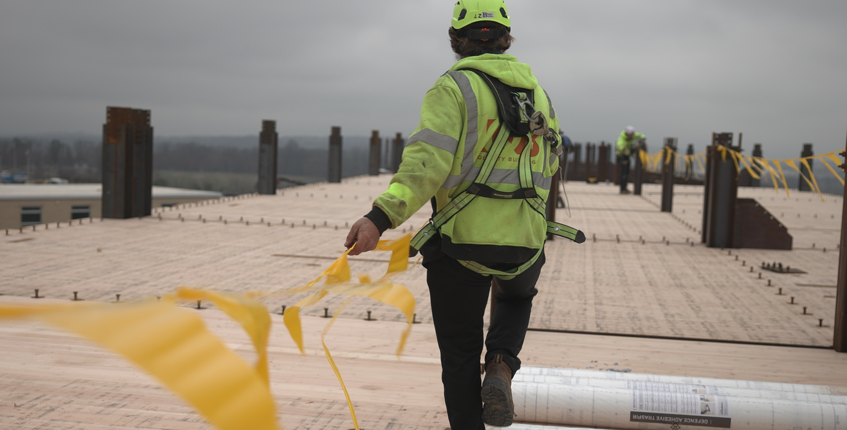 Installation crew positioning mass timber panels on active job site